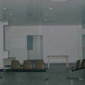 black and brown armchairs near white wall